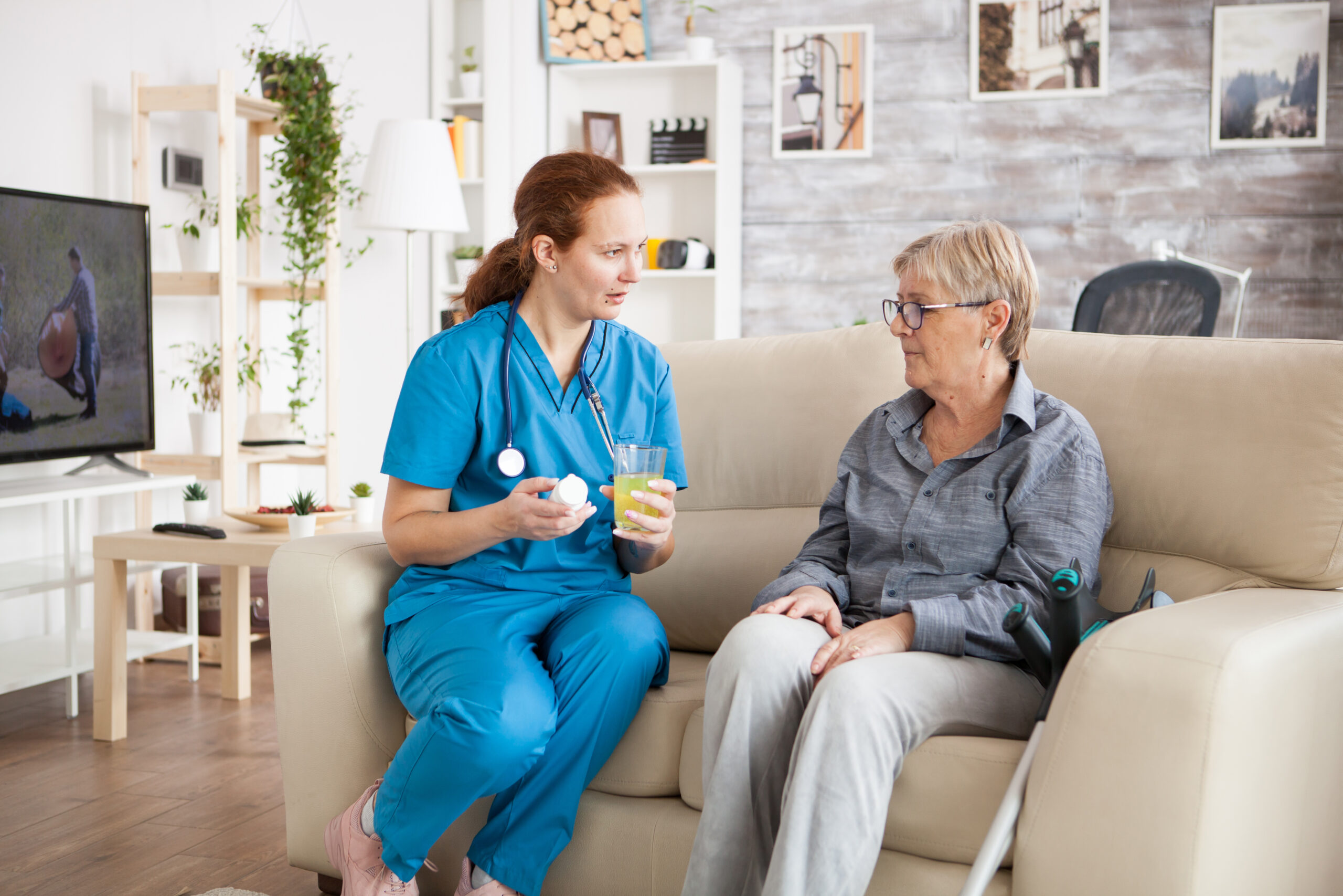 Female doctor talking with senior woman